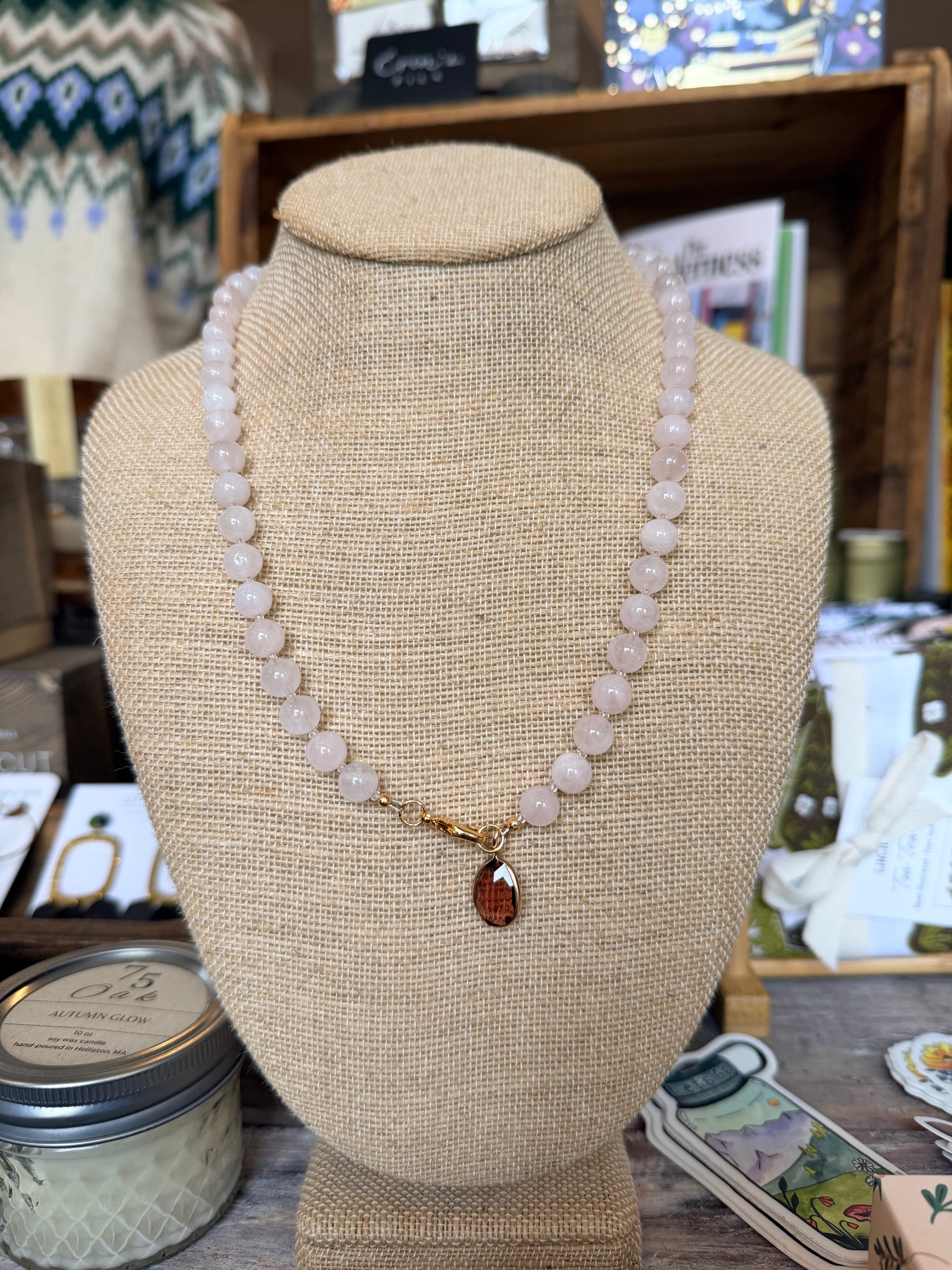 Necklace on a mannequin bust with a blurred store interior background